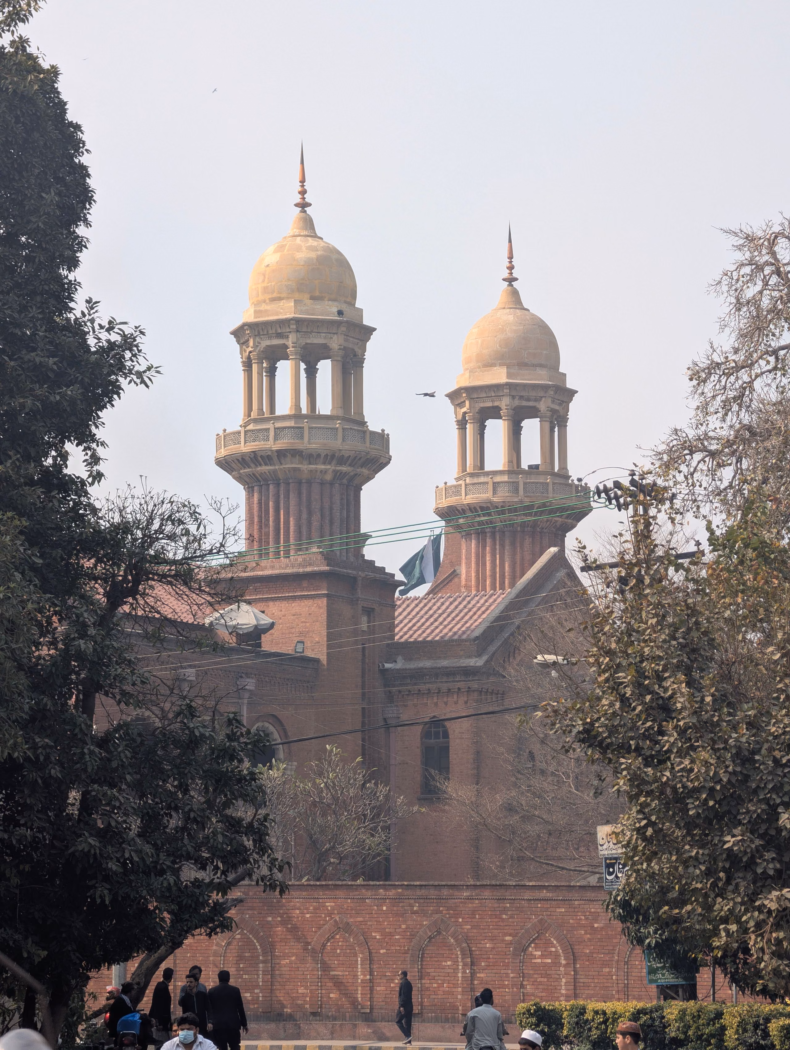 Red-brick Indo-Saracenic facade of the Lahore High Court on Mall Road, domed turrets above the entrance
